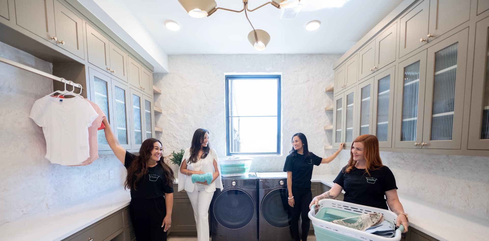 The Cesta Provider Community — four team members in a bright laundry room with washers and cabinetry